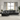 Modern black leather sectional sofa with reclining feature, set in a bright living room with large windows and contemporary decor.