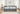 gray daybed with trundle tufted back nailhead rolled arms in white background