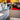 asy furniture showroom  gray sofa with pillows and red rug