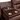 A close-up view of the Rosewood leather power reclining loveseat's center console, showcasing two stainless steel cup holders, a wood-textured panel with integrated power outlets and USB ports, offering a modern, convenient charging solution for users.