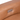 Close-up of a tan leather recliner control panel with two buttons for adjusting the seating position and a USB port.