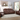 A full-room view of the Rosewood leather reclining sofa set, captured in a well-lit living room with natural light streaming through large windows, showing the couch in its reclined position for maximum comfort.