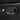 Close-up of a black leather recliner control button, with a metal accent and a toggle lever for reclining adjustments.
