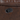 Close-up of a reclining lever on a brown leather recliner.