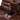 A close-up of the cup holders and hidden storage in the center console of the Rosewood loveseat, showing the design elements and functionality of the piece.